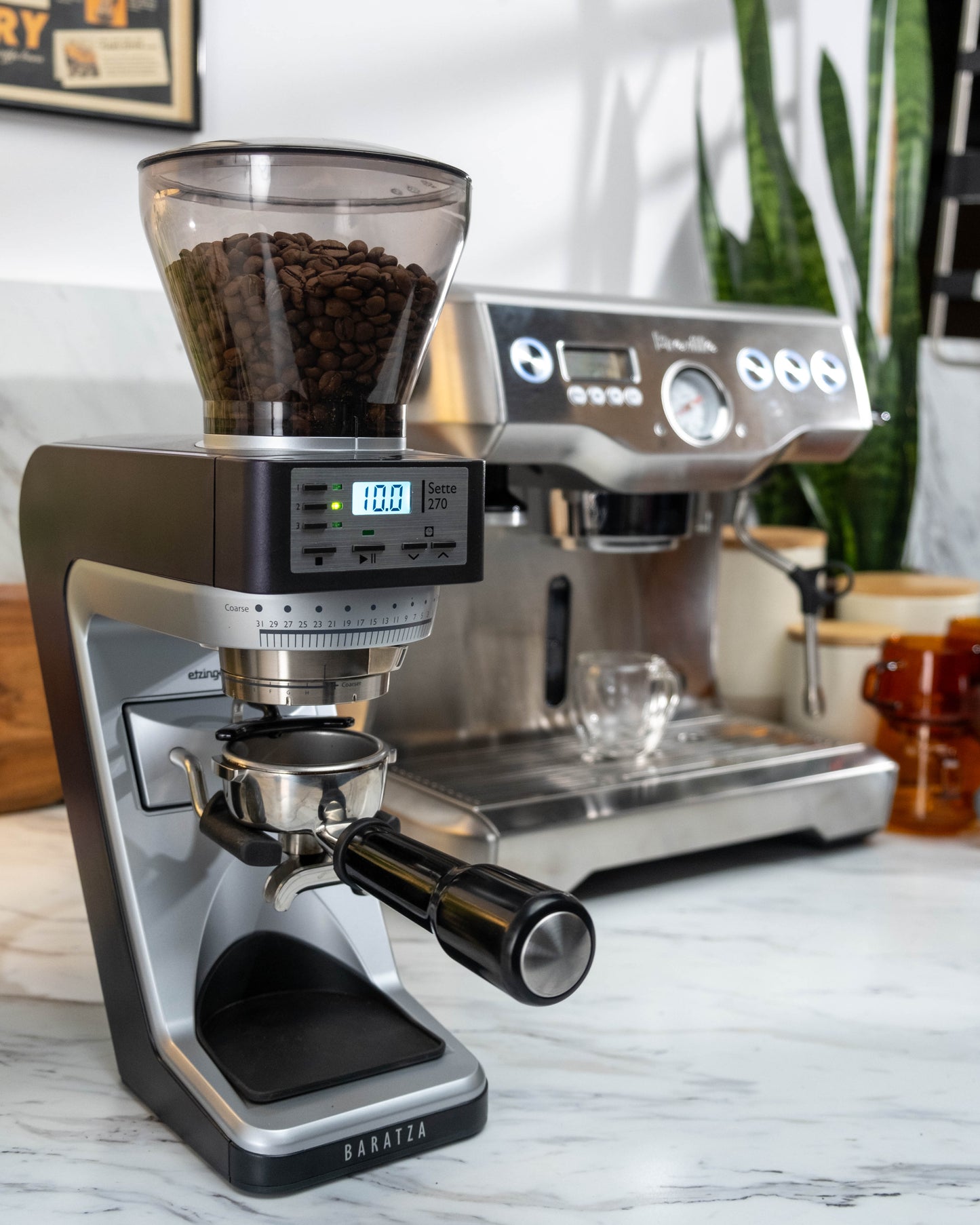 image of coffee grinder with espresso machine in background
