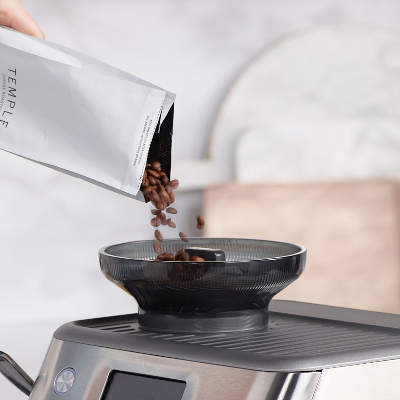 image of coffee beans being poured into espresso machine hopper