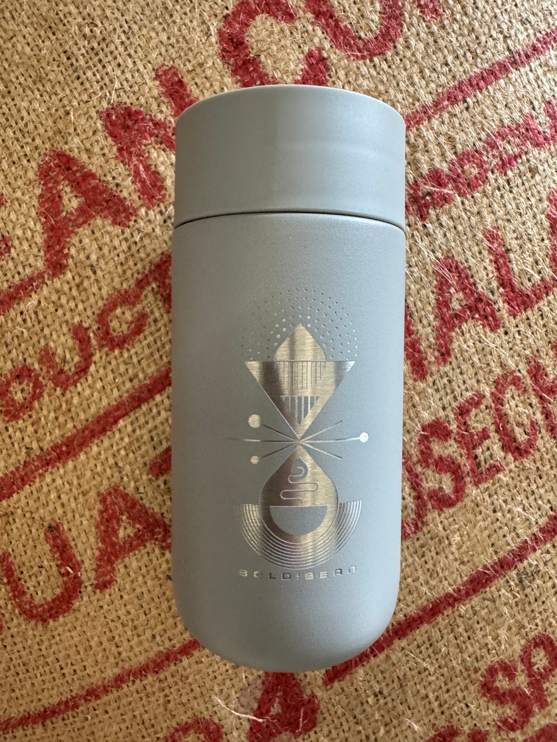 photo of grey coffee travel mug with logo