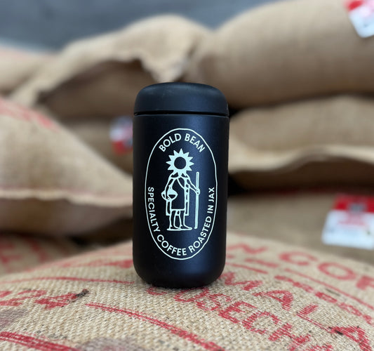 Black coffee tumbler with 'Bold Bean' logo on a background of burlap sacks.