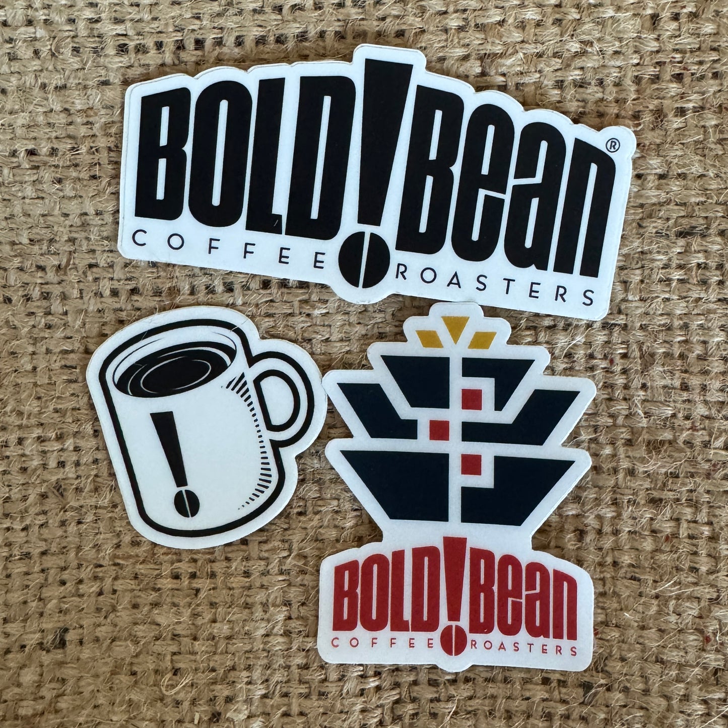 Three 'Bold Bean Coffee Roasters' stickers on a textured brown background