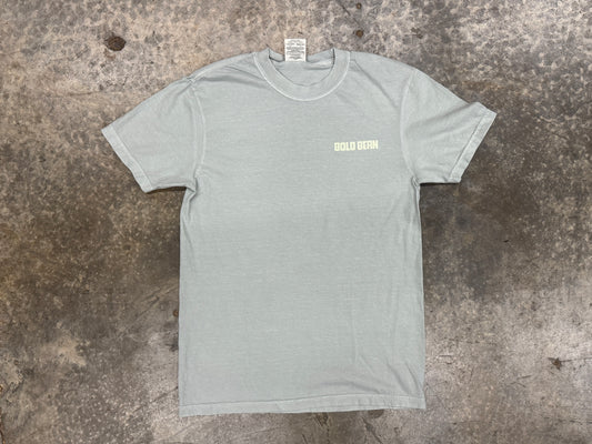 Gray t-shirt with a logo on a textured surface