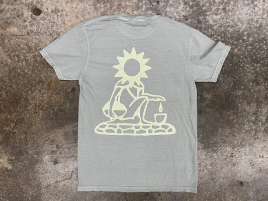 Gray t-shirt with a white graphic design on a textured surface
