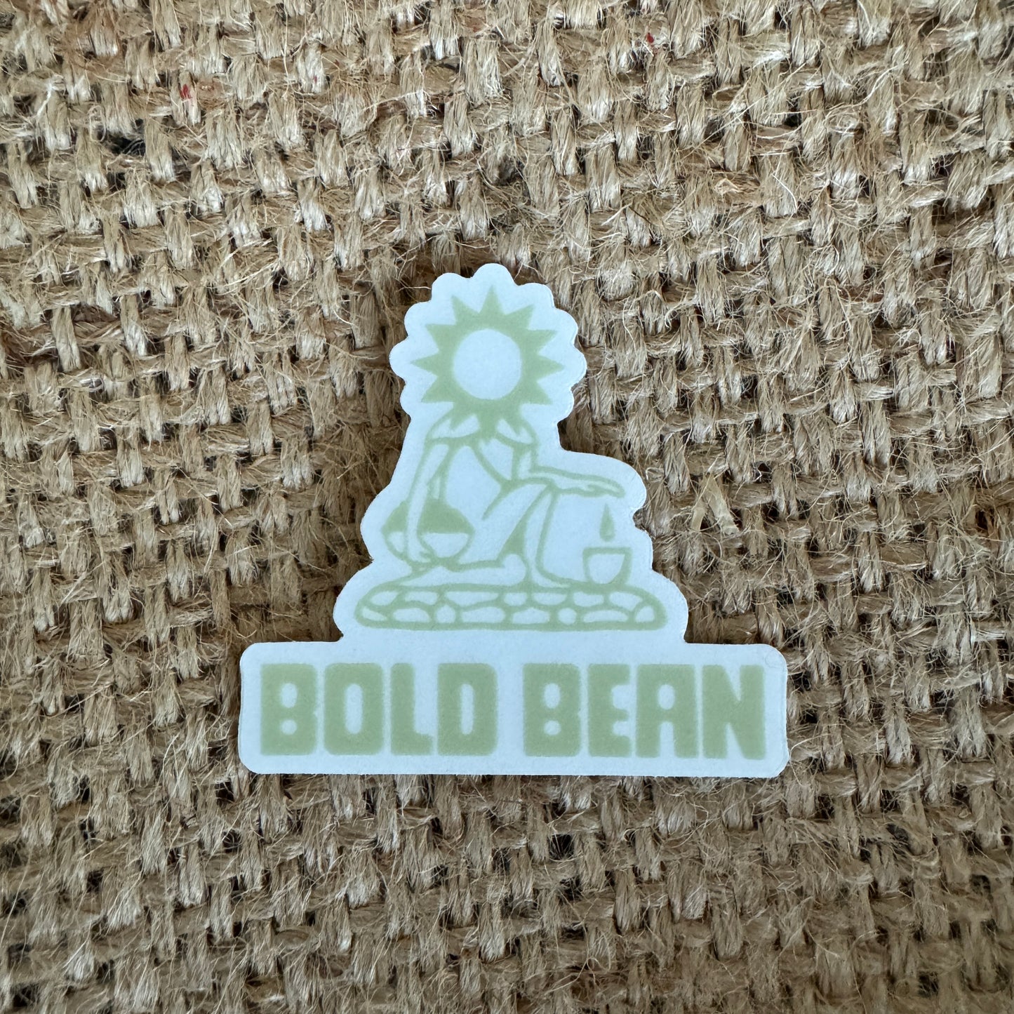 Sticker with 'BOLD BEAN' text and logo on a textured beige background