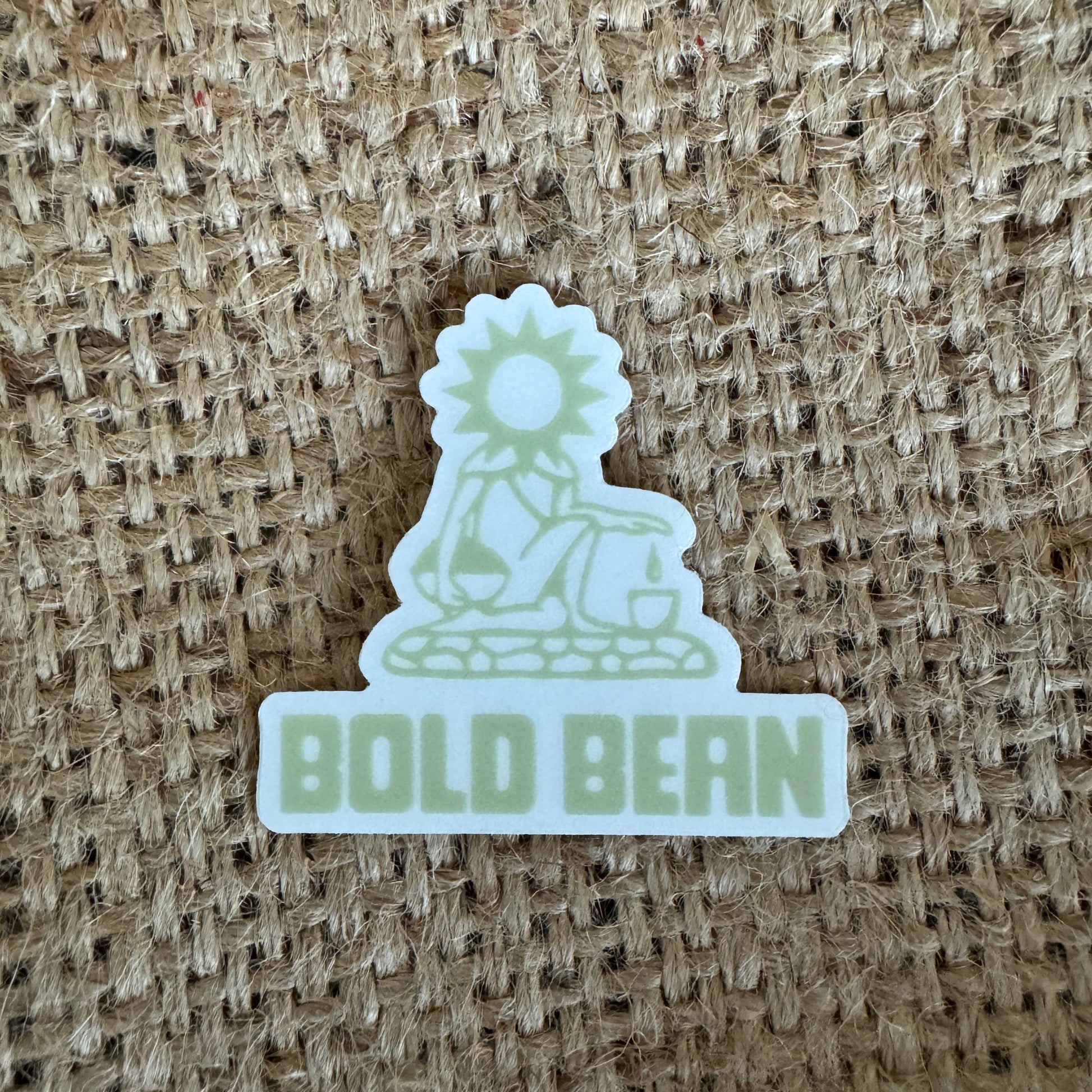 Sticker with 'BOLD BEAN' text and logo on a textured beige background