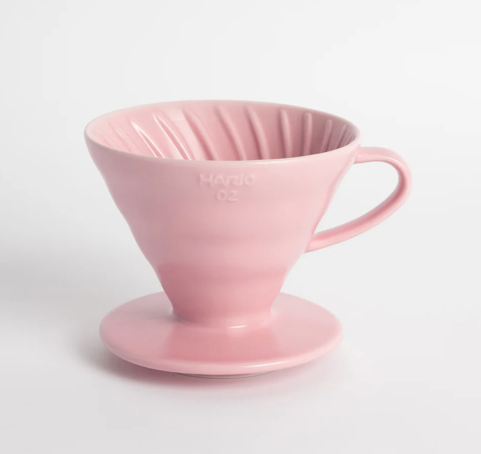Pink ceramic coffee dripper on a white background