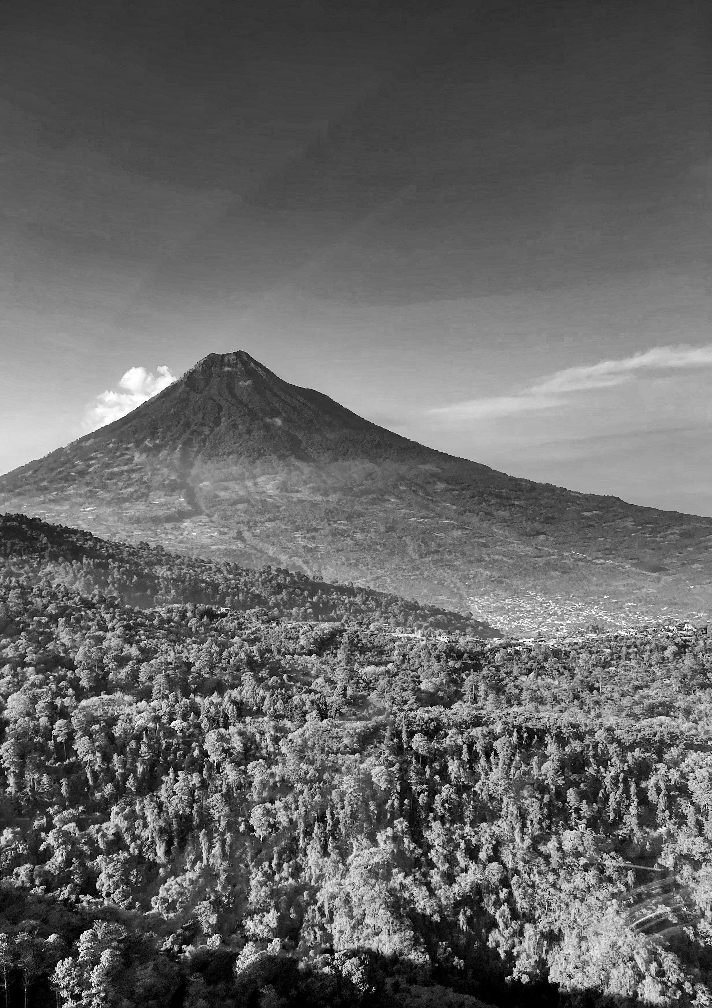 Black and white photograph of a mountain with a cityscape in the foreground