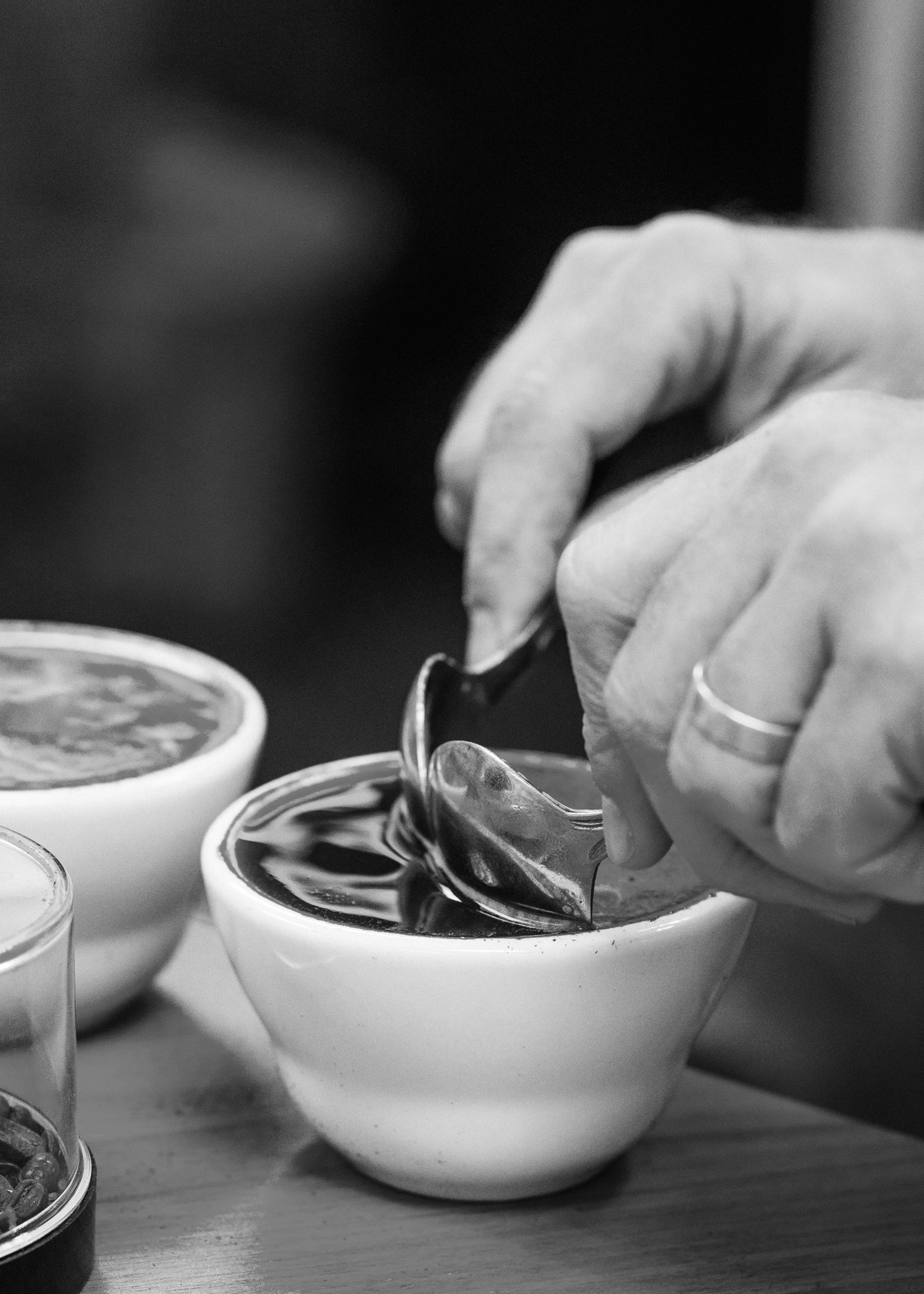 image of persons hands pipping cupping spoons into cupping bowl